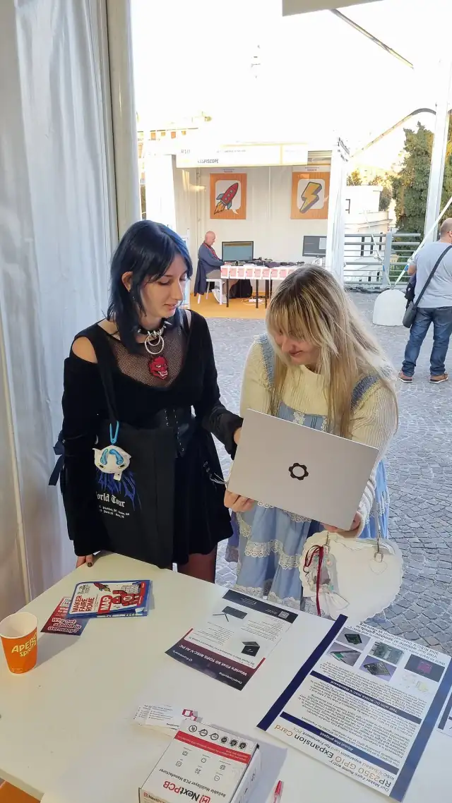 2 girls testing an expansion card on Framework Laptop 13