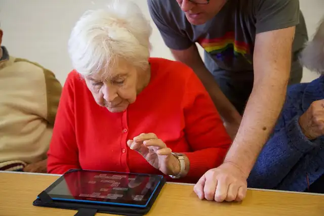 An Essex Dementia Care visitor using a tablet computer given by WaveLength charity.
