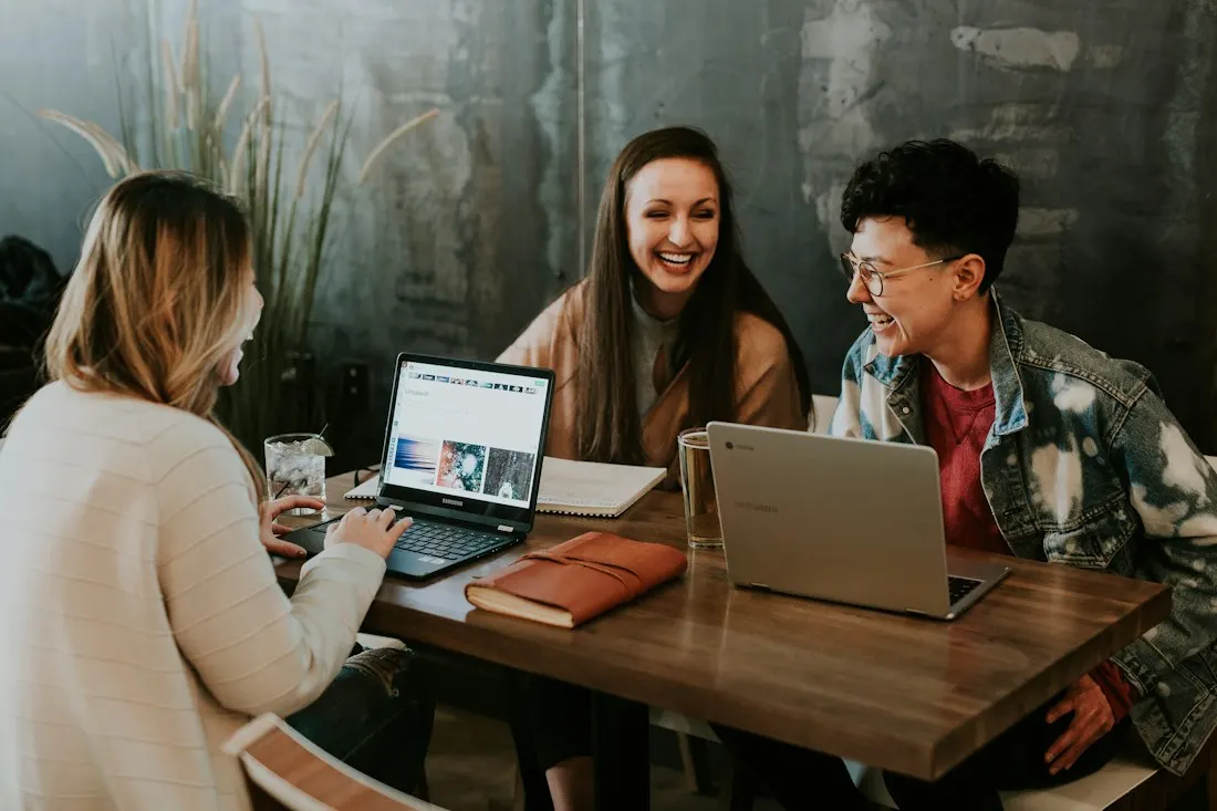 People reviewing work together at a table