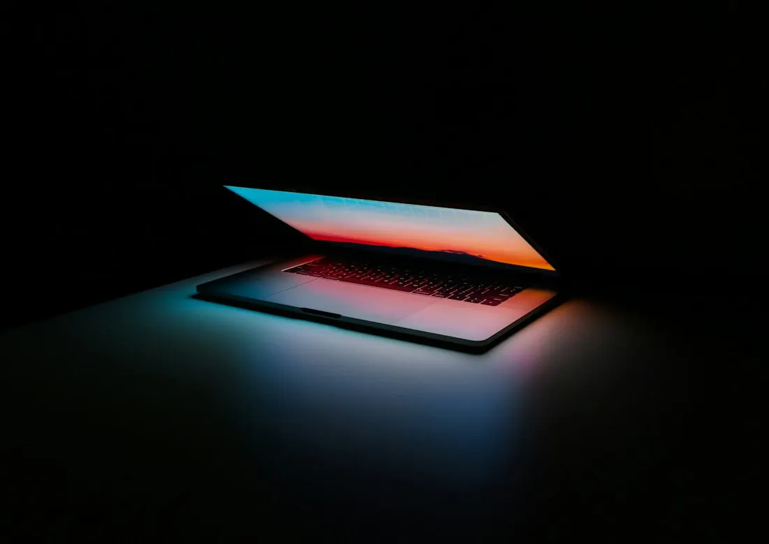 A laptop illuminated by blue and red light