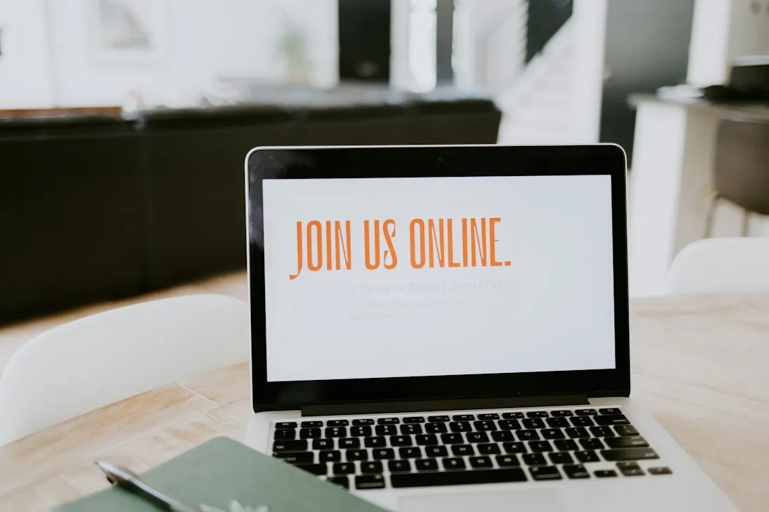An open laptop displaying a join us online message