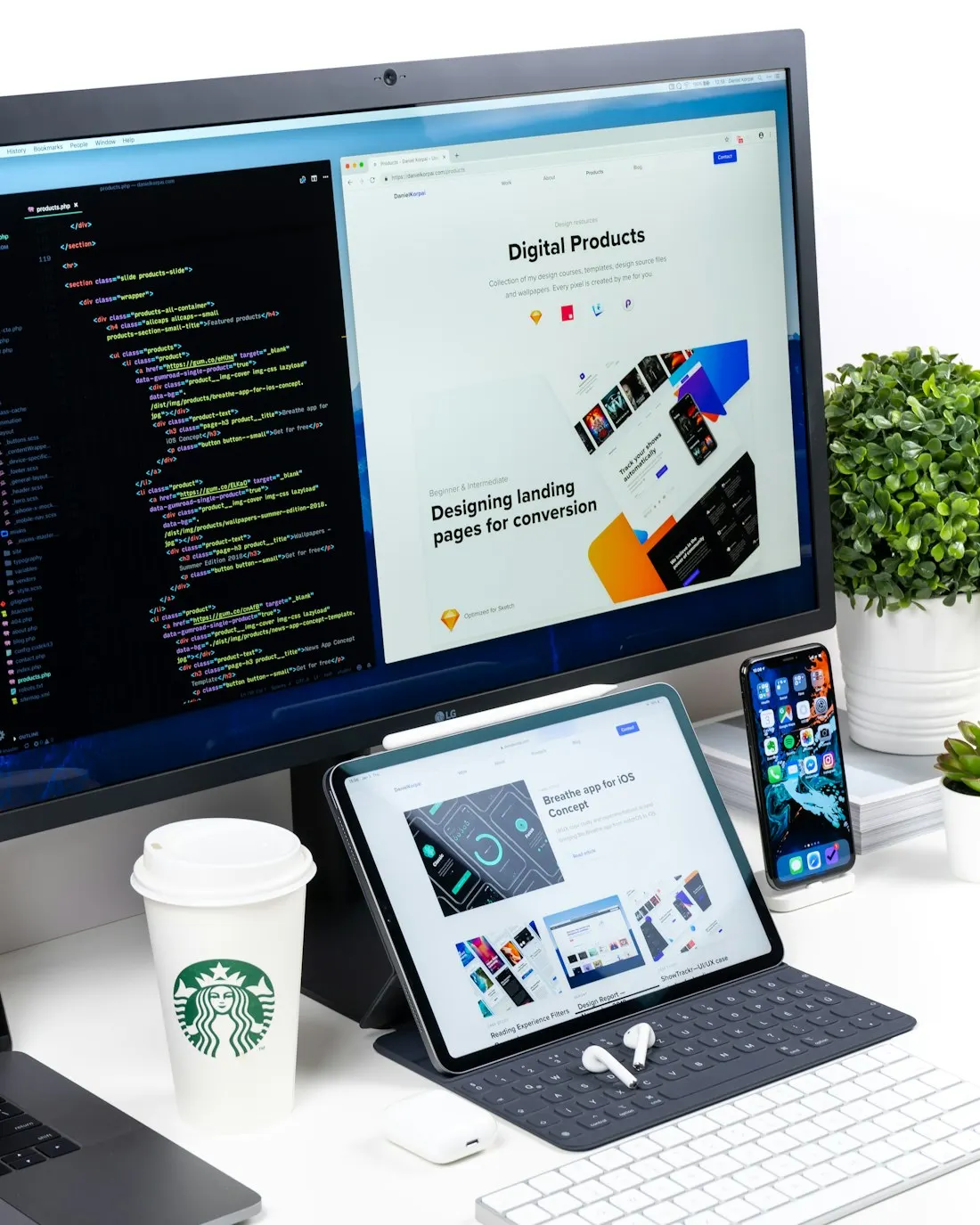 A laptop and monitor displaying a website project