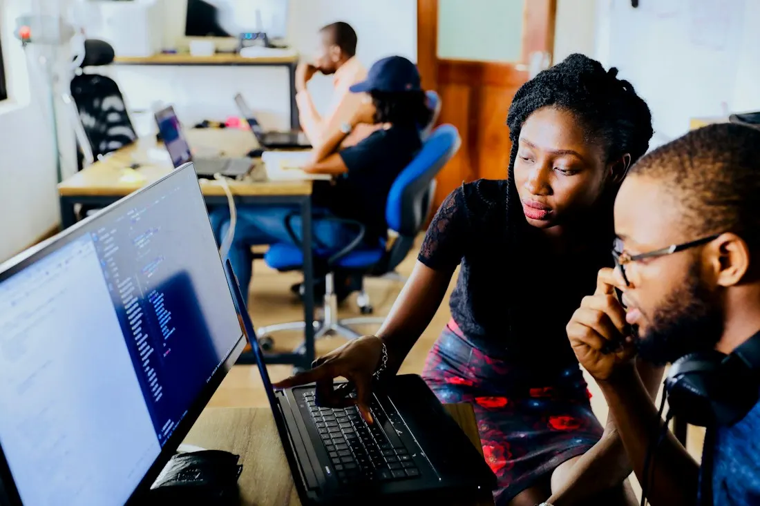 Colleagues examining a laptop screen