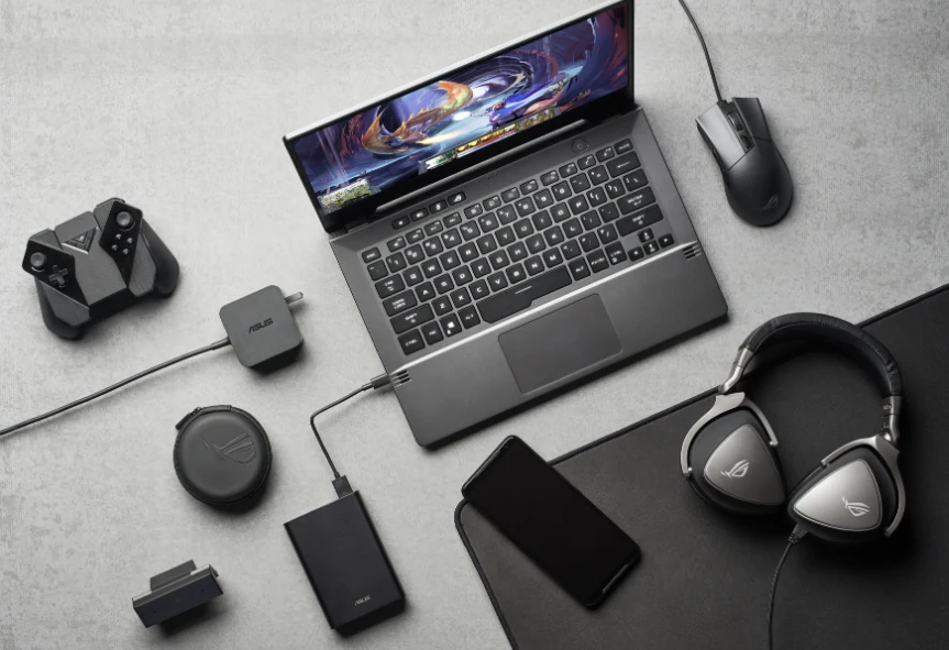 Laptop and everyday computer accessories arranged on a desk