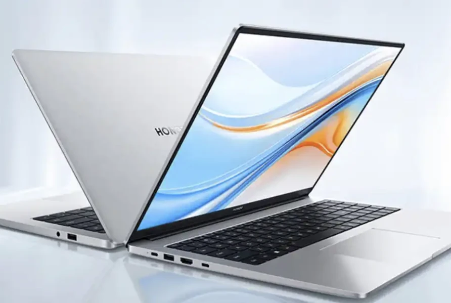Two slim silver laptops with their screens and side ports visible