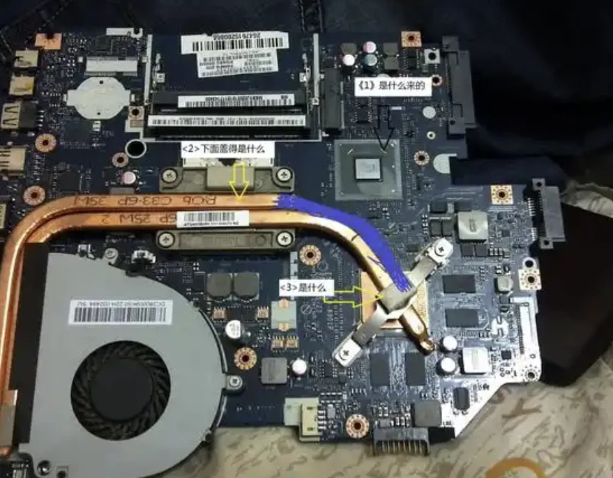 Laptop cooling fan and copper heat pipe on an exposed motherboard