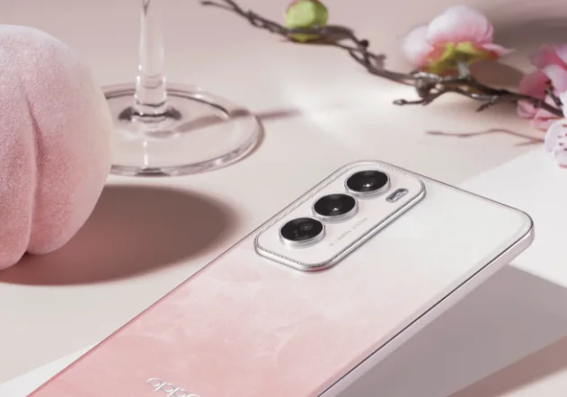 A pink smartphone with three rear cameras on a table