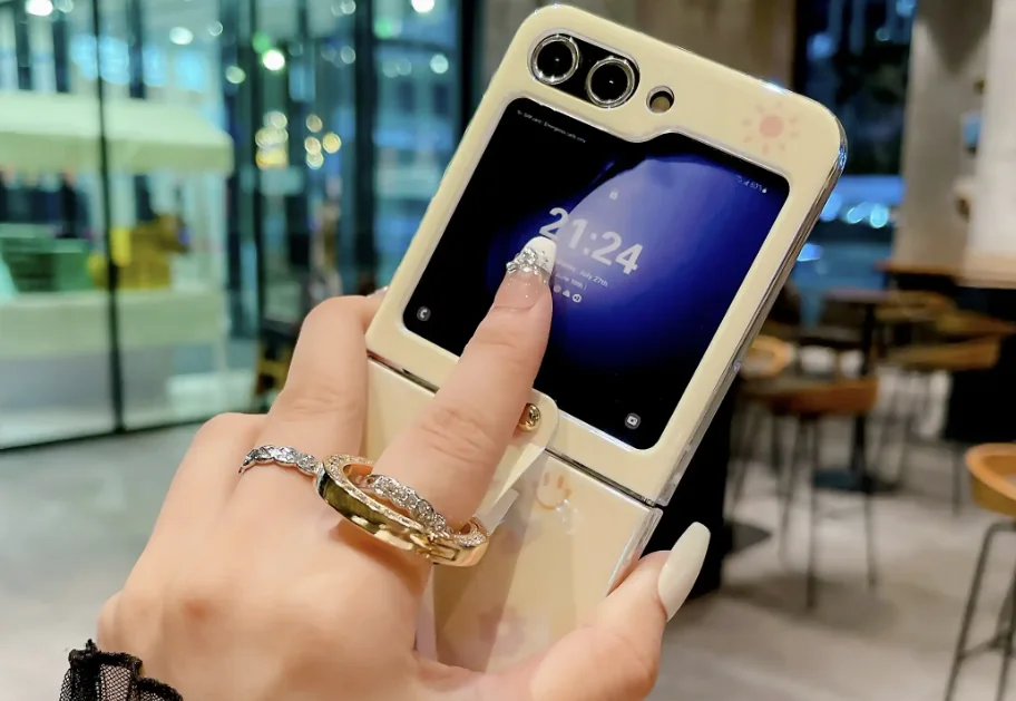 A person using the cover display of a folding smartphone