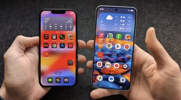 Two smartphones held side by side with their home screens visible